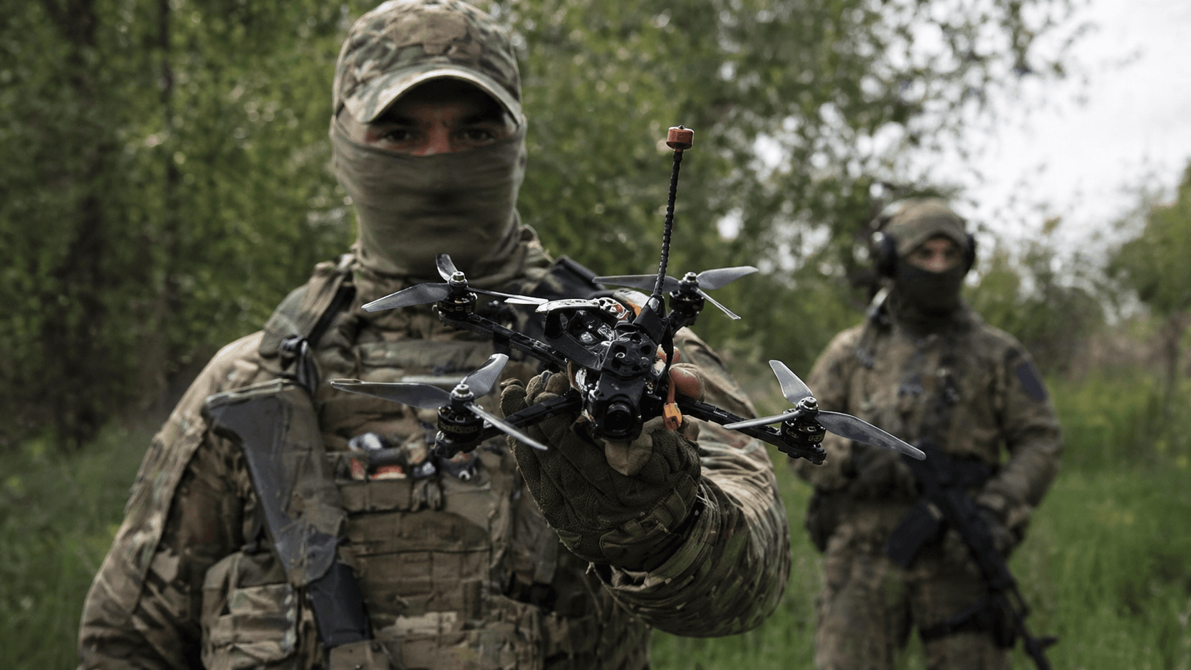 Field operator holding an FPV drone during mission preparation for tactical deployment