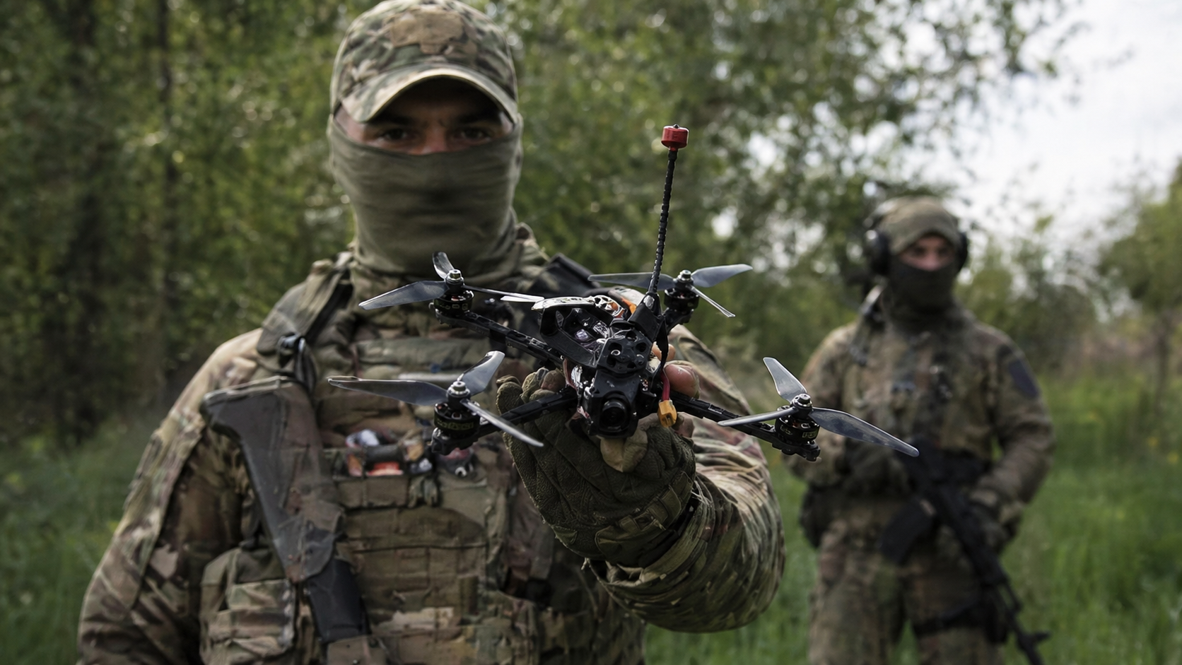 Field operator holding an FPV drone during mission preparation for tactical deployment